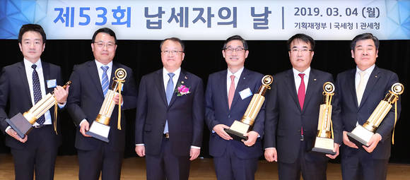 ▲4일 KEB하나은행은 서울 코엑스 컨벤션 센터에서 열린 제53회 납세자의 날 기념행사에서 모범 납세 기업으로 국가 재정에 기여한 공로를 인정받아 '고액납세의 탑'인 '국세 6000억 원 탑'을 수상했다고 밝혔다. 시상식 후 이후승 KEB하나은행 경영기획그룹장(사진 왼쪽 네 번째)이 한승희 국세청장(사진 왼쪽 세 번째) 등과 기념촬영을 하고 있다.(사진제공=KEB하나은행)