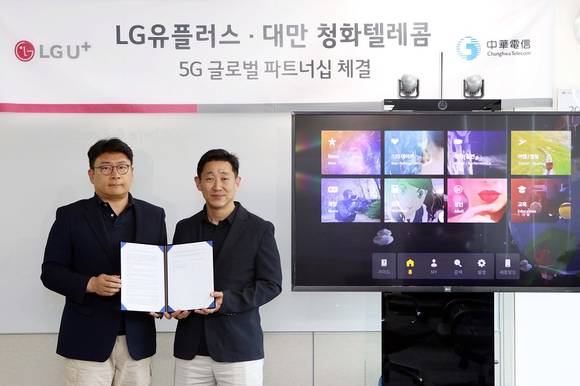 ▲김준형 LG유플러스 5G서비스그룹장(오른쪽), 최윤호 LG유플러스 AR/VR서비스담당이 원격 화상회의를 통해 청화텔레콤과 5G 수출계약을 맺은 뒤 기념촬영을 하고 있다. / 사진=LG유플러스