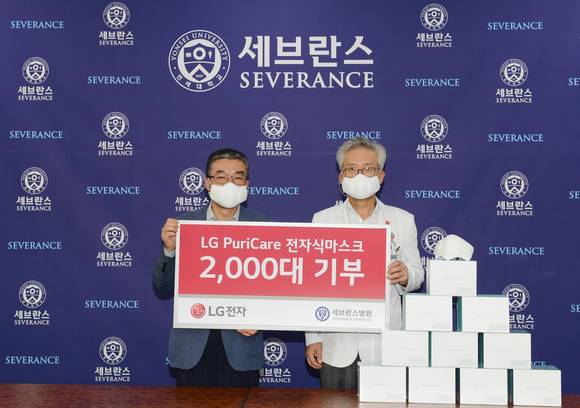 ▲LG전자가 10일 서울 서대문구 연세대 세브란스병원에서 전달식을 열고 전자식 마스크 2000개를 기부했다. 이감규 LG전자 에어솔루션사업부장(왼쪽)과 이병석 연세대 세브란스병원장이 기념촬영을 하고 있다. / 사진=LG전자