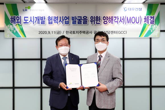 ▲김창환 대우건설 신사업본부장(왼쪽)과 이용삼 한국토지주택공사 글로벌사업본부장이 양해각서 체결 후 기념촬영을 하는 모습 / 사진=대우건설