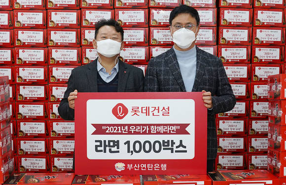 ▲김재권 롯데건설 영남지사장(왼쪽)과 강정칠 부산연탄은행 대표가 사랑의 라면 나눔 기념 촬영 중이다 / 사진=롯데건설	