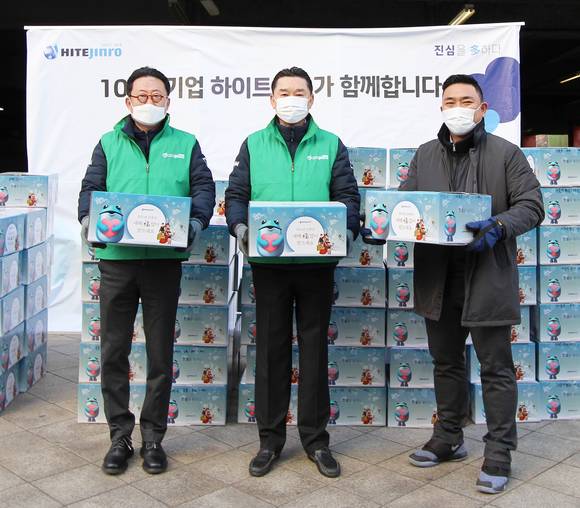 ▲김인규 하이트진로 대표(가운데)가 2일 서초동 본사 사옥 앞에서 34개 사회복지기관에 가래떡과 만두 약 1만인분을 전달했다. / 사진=하이트진로