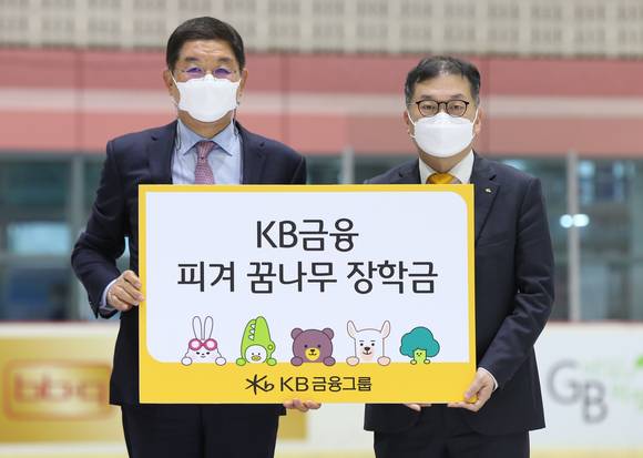 ▲김진영 KB금융 브랜드ESG총괄 상무(오른쪽)가 김홍식 대한빙상경기연맹 상임 부회장에게 'KB금융 피겨 꿈나무 장학금'을 전달하고 기념촬영을 하고 있다. / 사진=KB금융그룹