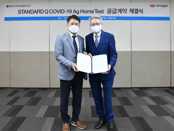 ▲우종수 한미약품 대표이사(오른쪽)와 허태영 SD바이오센서 대표이사가 유통 계약 체결 후 사진 촬영을 하고 있다. / 사진=한미약품