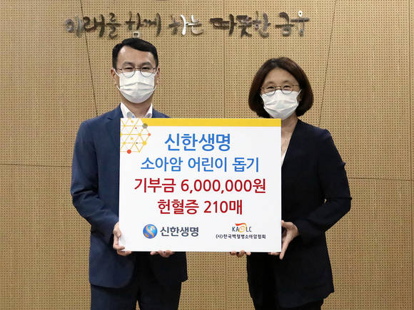 ▲조형엽 신한생명 전략기획그룹장(왼쪽), 허인영 한국백혈병 소아암협회 사무국장이 '헌혈증 및 기부금 전달식'을 갖고 기념촬영을 하고 있다. / 사진=신한생명