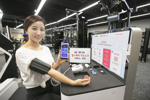 ▲KT가 생체데이터를 AI로 분석하는 기술을 보유한 스타트업 제나와 헬스케어 키오스크 서비스 사업을 시작한다. 사진은 모델이 헬스케어 키오스크에서 건강 정보를 측정하는 모습 / 사진=KT