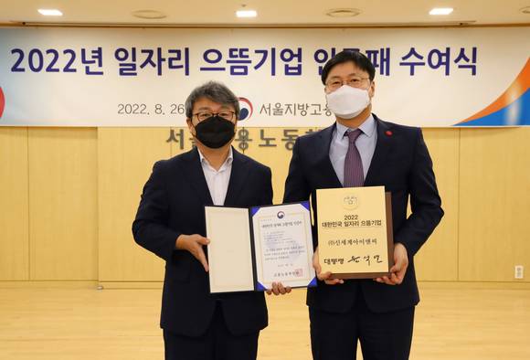 ▲김승환 신세계아이앤씨 지원담당 상무(오른쪽)와 노길준 서울고용노동청장이 26일(금) 서울 중구에 위치한 서울고용노동청에서 진행된 ‘2022 대한민국 일자리 으뜸기업 인증패 수여식’에서 기념촬영을 하고 있다. / 사진=신세계아이앤씨