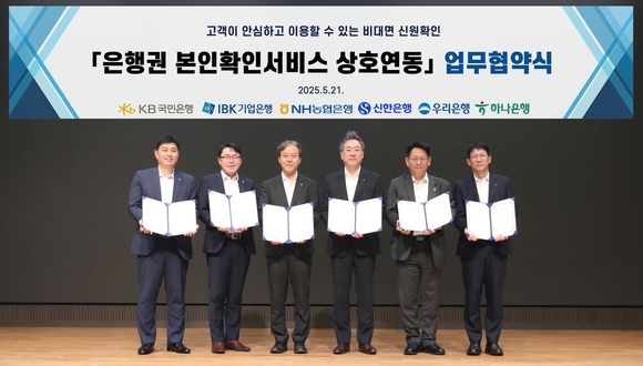 ▲(왼쪽부터) 박형주 국민은행 스타뱅킹영업본부 본부장, 박필희 기업은행 데이터본부 본부장, 유일봉 농협은행 개인디지털플랫폼부 부장, 전성익 신한은행 디지털솔루션본부 본부장, 김규태 우리은행 WON뱅킹사업본부 본부장직무대리, 엄태성 하나은행 디지털채널본부 본부장이 21일 우리은행 본점에서 열린 '인증서 본인확인 서비스' 상호 연동을 위한 업무협약 체결식에서 기념사진을 촬영하고 있다. / 사진=우리은행 우리은행, 6개 시중은행과 인증서 본인확인 서비스 상호 연동 MOU