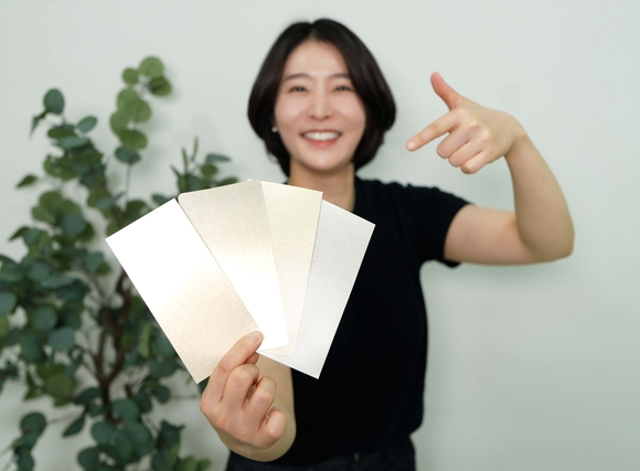 ▲KCC 관계자가 실제 금속(왼쪽에서 두 번째)과 숲으로메탈릭을 칠한 종이(그 외 3개)를 비교하고 있다. / 사진=KCC KCC, ‘숲으로메탈릭’ 출시로 메탈릭 도료 라인업 강화